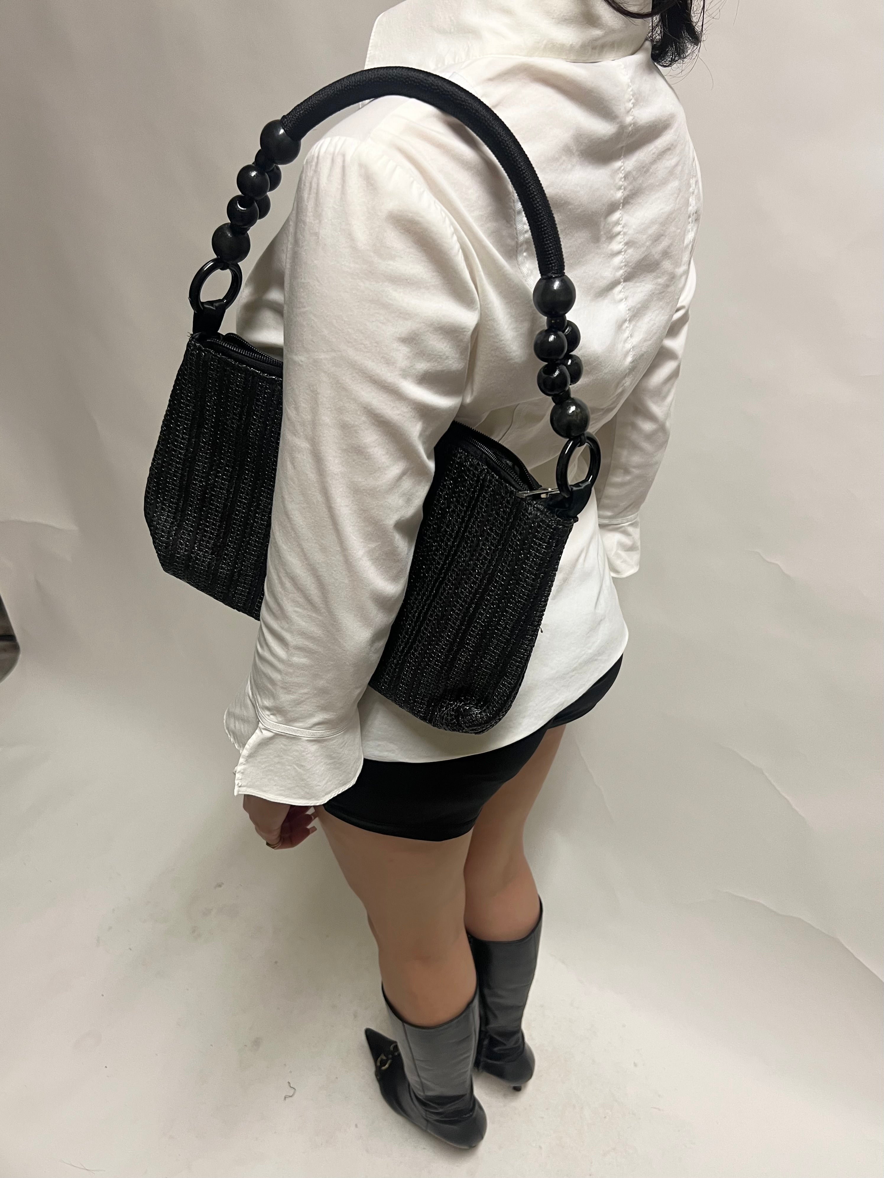 Black beaded handle woven bag